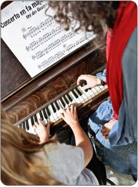 in home piano teacher giving advanced private piano lesson
