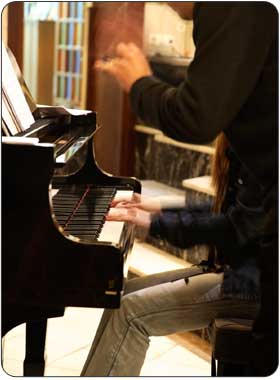 in home piano teacher giving advanced private piano lesson
